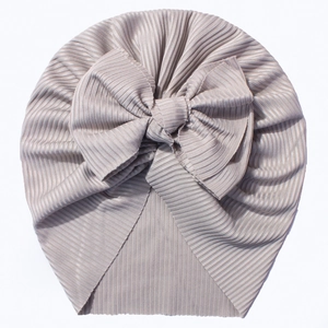 Detail of grey ribbed knit baby turban hat featuring a large soft decorative bow