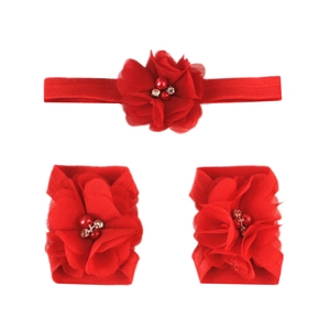 Detail of red chiffon flower baby headband and foot floral set with rhinestones and pearls