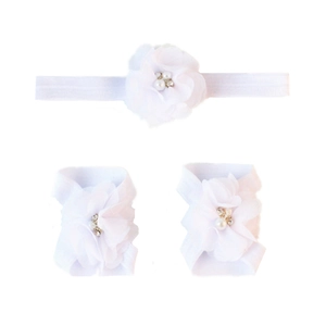 Detailed view of white chiffon flower headbands and barefoot sandals set for babies