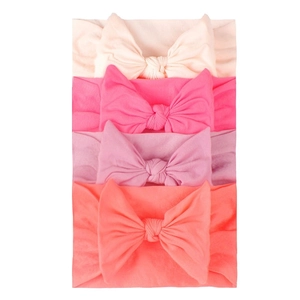 Set of 4 soft nylon baby headbands with large bows in white, pink, purple, and orange