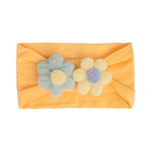 Close-up of soft nylon baby headband with green and yellow felt flower details