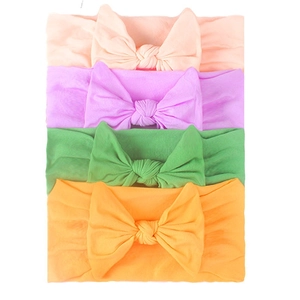 Set of 4 soft elastic nylon headbands with large bows for infants in vibrant colors