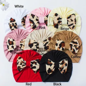 Detailed view of eight colors of ribbed baby turbans with large leopard print bows