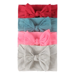 Detail showing four assorted soft elastic nylon headbands with large bows for babies