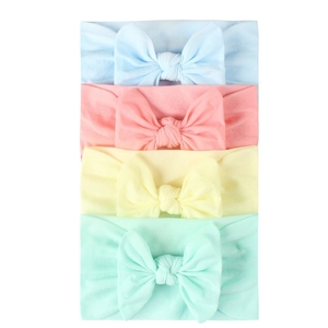 Detail of four soft nylon elastic headbands for infants in pastel macaron colors