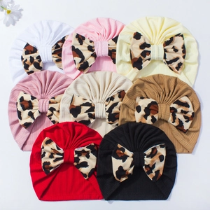 Detailed top view of soft ribbed baby turbans in eight colors with leopard print bows