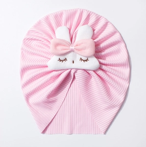 Pink ribbed infant turban hat featuring a cute white rabbit doll with 3D bow decoration