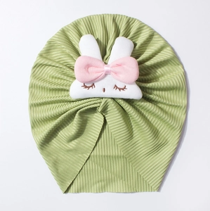 Close-up of green ribbed baby turban hat with a cute handmade 3D plush rabbit detail