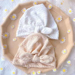 Newborn baby hats with cute bunny ear knots in soft white and beige knit texture