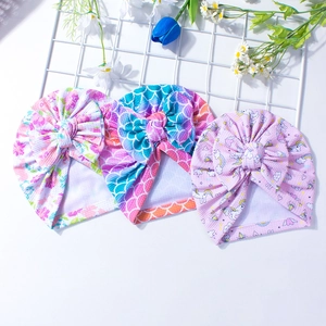 Baby turban hats with floral prints and waffle knit fabric with large bows