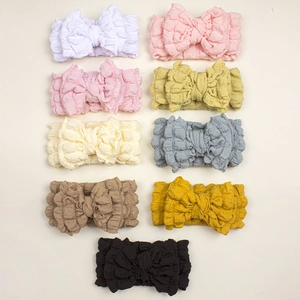 9-piece set of baby bow headbands in soft waffle knit fabric and diverse colors