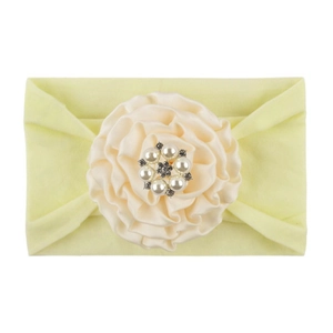 Detail of baby nylon headband with large yellow fabric flower and sparkling rhinestone center