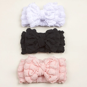 Set of 3 baby bow headbands in white black and pink with soft waffle texture fabric