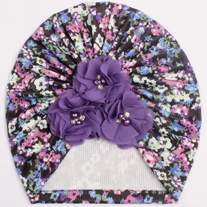Detail of floral baby turban hat featuring 3D mesh flowers with pearls and rhinestones