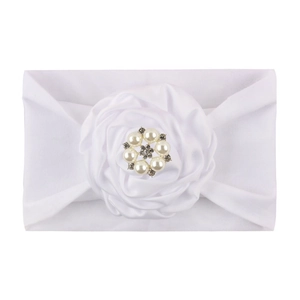 Detail of white nylon baby headband with satin rose flower and crystal pearl center