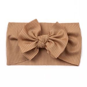 Détail du bandeau pour bébé en tricot côtelé marron avec un grand nœud souple