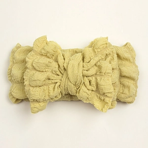 Creative baby bow headband in bright yellow bubble fabric with soft texture and chic design