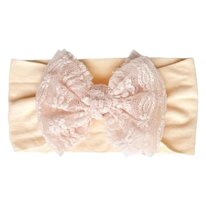 Soft peach stretch nylon baby headband featuring a delicate large lace bow for infant girls