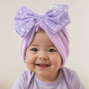Detail of purple baby turban with large tulle bow and silver geometric patterns
