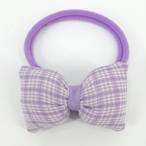 Detailed view of baby purple headband featuring a cute lilac gingham bow design