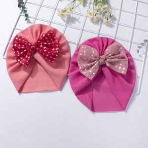 Cute waffle knit baby beanies with oversized silver star printed bows in pink and rose