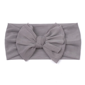 Close-up detail of soft greyish purple mesh fabric and bow knot on baby headband