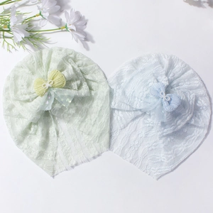 Breathable baby turbans with lace bows and pearl accents in mint green and light blue