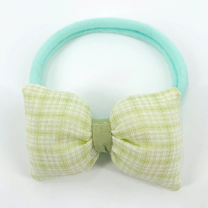 Detail of light green gingham bow headband with seamless elastic nylon band for babies