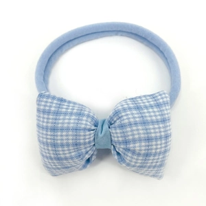 Detail of light blue plaid bow headband made with soft nylon fabric for infants