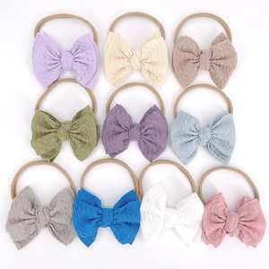 Lot de 10 bandeaux bébé en nylon souple avec des nœuds en tissu texturé coloré