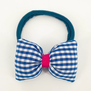 Detail of blue gingham plaid bow headband with elastic nylon band for baby girls