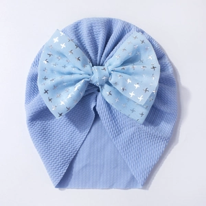 Detail of light blue baby turban with textured knit and silver star bow accent