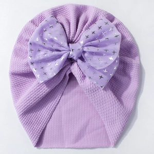 Detail of lavender baby turban hat featuring a mesh bow with silver bird prints
