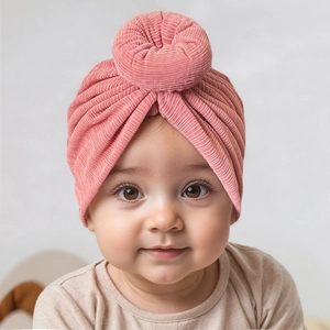 Detailed close-up of soft ribbed texture on baby donut turban hat in dusty rose pink