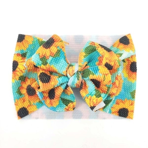 Elastisches Baby-Stirnband mit Sonnenblumenmuster und großer Schleife aus Waffelstrick