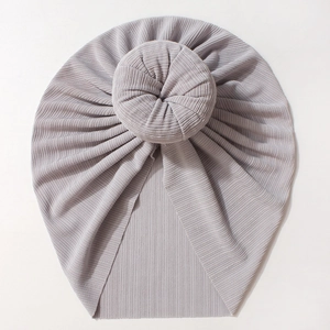 Close-up of light purple baby turban hat with pleated donut knot and ribbed fabric texture