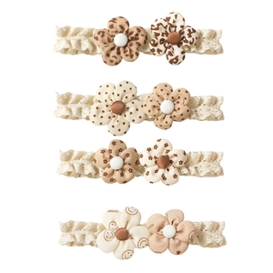 Set of four lace floral baby headbands with leopard and polka dot patterns in earth tones
