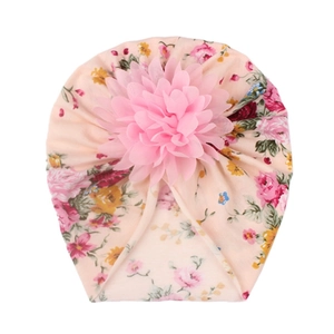Detail of baby floral turban hat with a large pink 3D chiffon flower on soft cotton