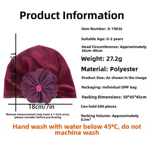 Detail view of purple velvet baby turban with large fabric flower and size specifications