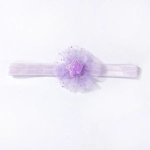 Detail of baby headband featuring purple mesh flower and glittering star ornament