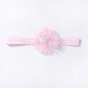 Detail of pink mesh baby headband featuring a ruffled tulle flower and glitter star center