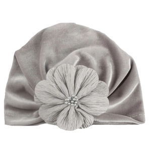Detailed close-up of gray velvet baby hat featuring a large fabric flower and faux pearls