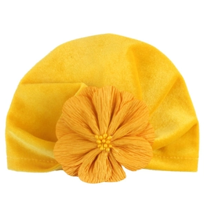 Soft gold velvet baby beanie with a large orange fabric flower and bead detail