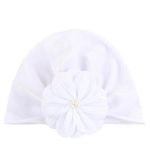 Close-up of white baby turban hat with a large soft flower and pearl bead detail