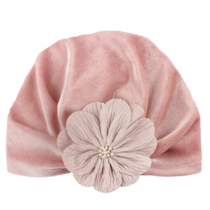 Soft pink velvet baby turban hat with a large pearl-centered flower on white background