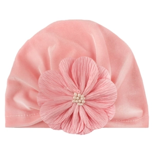 Detail of pink velvet baby turban hat with a layered fabric flower and pearl beads
