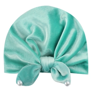 Mint green velvet baby turban hat featuring a decorative bow with pearl embellishments