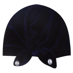 Detail of navy velvet baby hat featuring a stylish knot and two decorative white pearls