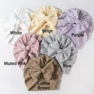 Detailed view of soft knit baby turbans featuring 3D jacquard texture and big bows