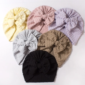 Solid color baby turban hats with large bows and dotted texture in six assorted colors